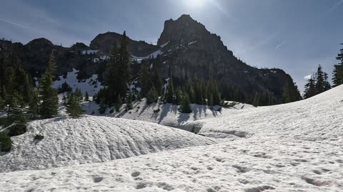 Snowfield below the rocky summit of Mount Daniel